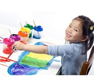 Preschool girl playing with paint