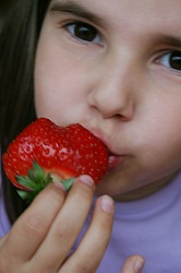 girl eating strawberry
