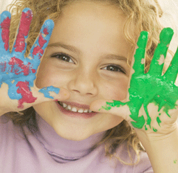preschool child with paint on hands