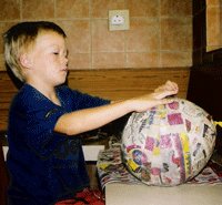 Glue strips of newspaper over the balloon.