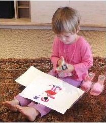 Preschool child drawing with stencils