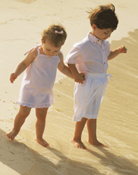 preschool siblings on a sand dune at the beach
